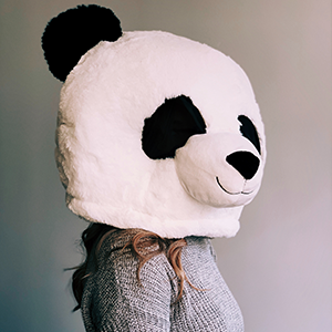 An image of a girl wearing a panda mask.