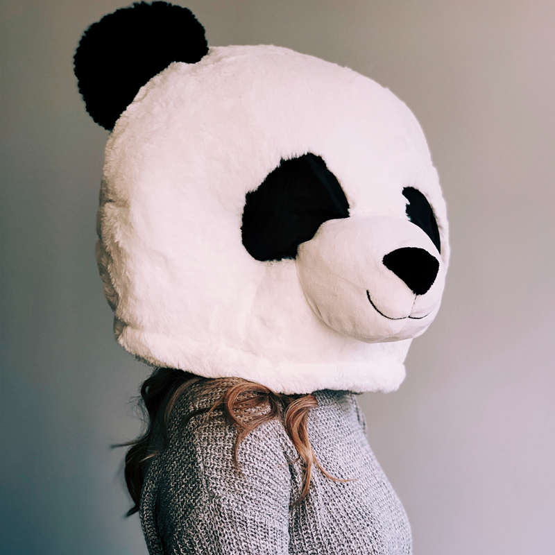 An image of a girl wearing a panda mask.